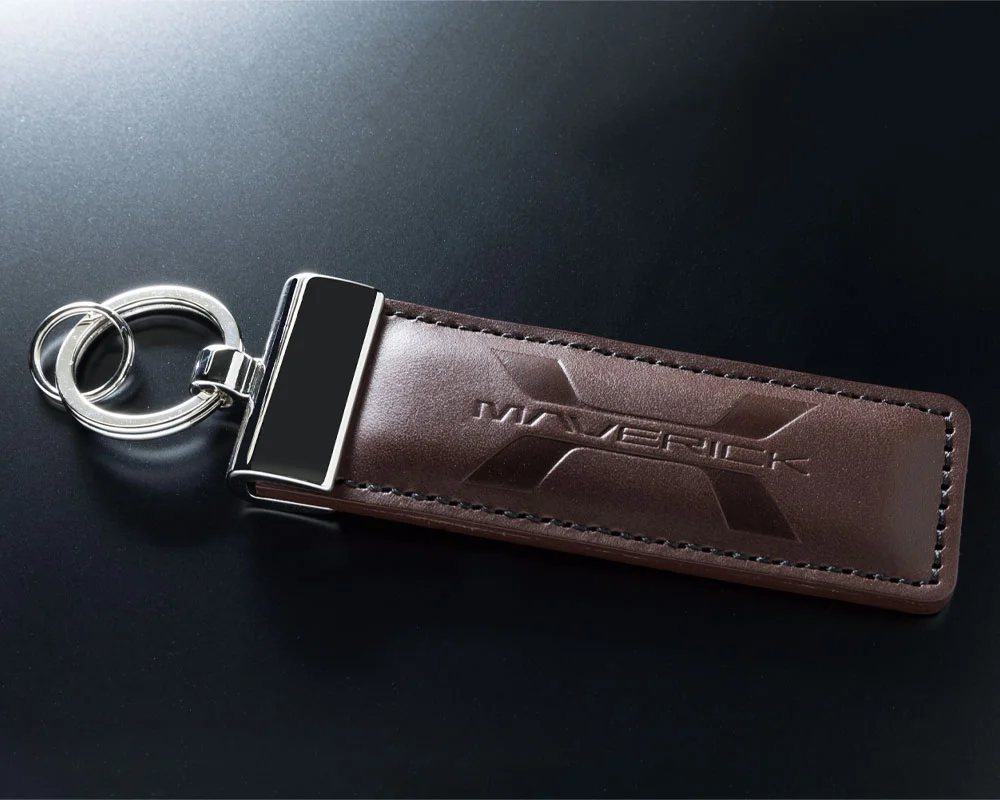 A key chain with a leather strap on it.