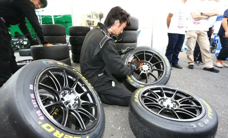 A man is working on some tires