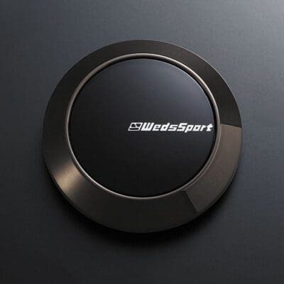 A black button with the word wildsport on it.