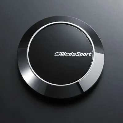A black button with the word wds sport on it.