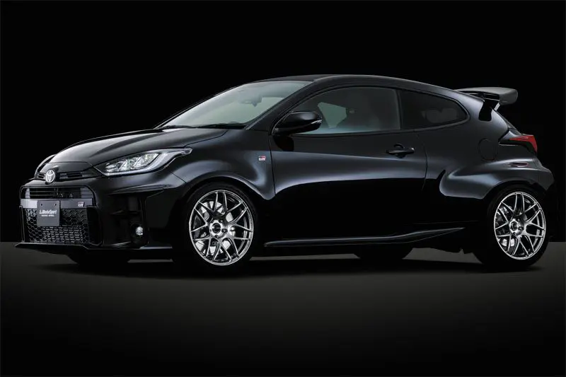 The black toyota yaris is shown in a dark background.