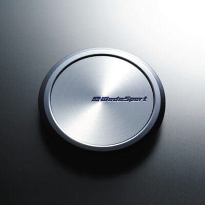 A silver button with the word sport on it.
