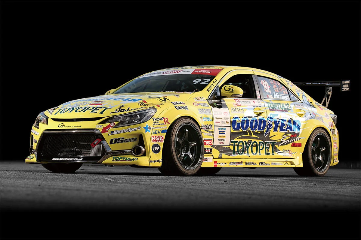 A yellow toyota corolla racing car on a black background.