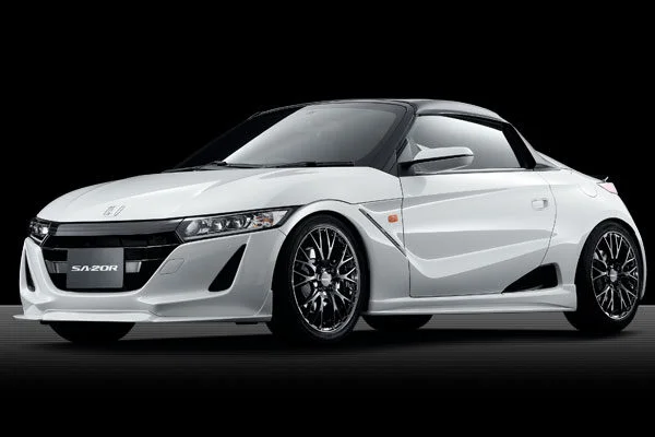 The white honda s2000 sports car is shown in a black background.
