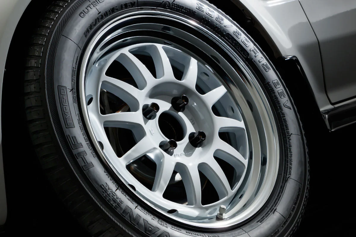 A close up of a white car tire with Weds Sport branding.