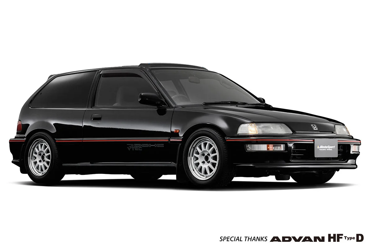 A black Honda Civic hatchback with Weds Sport wheels on a white background.