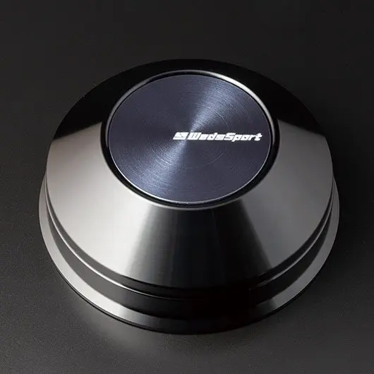 A black button with the word blacksport on it.