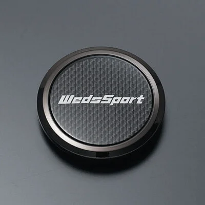 A black button with the word wedsport on it.