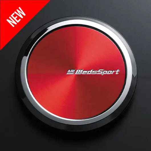 A red button with the word wide sport on it.