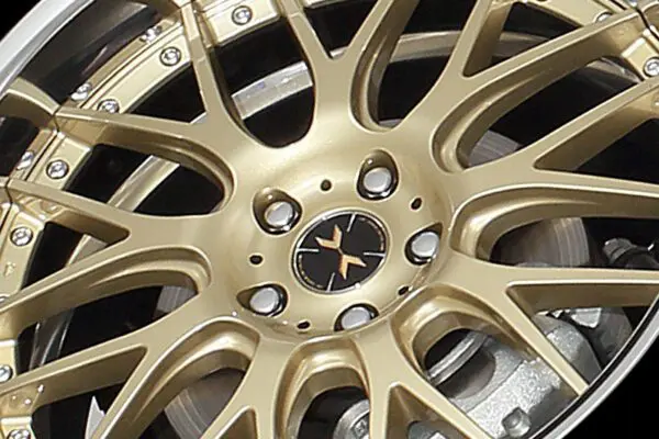 A close up of a gold rim on a black background.