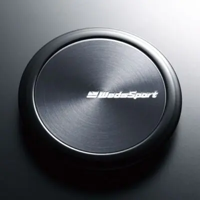 A black button with the word blacksport on it.