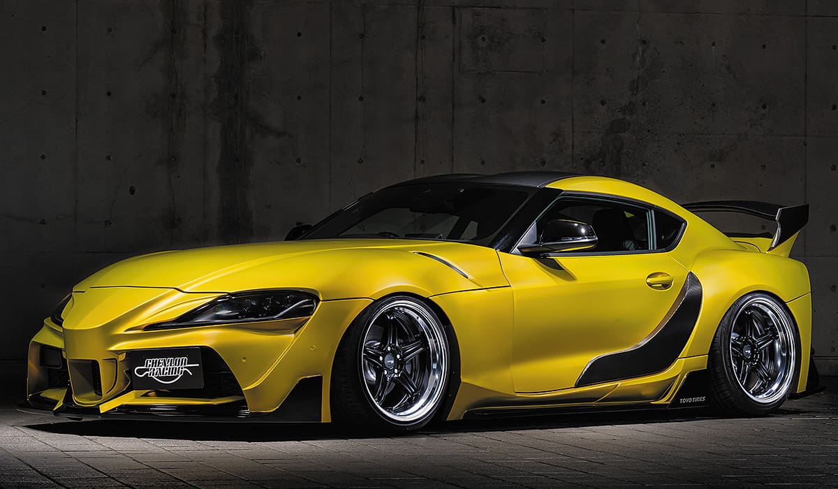 Yellow Toyota Supra with black accents.